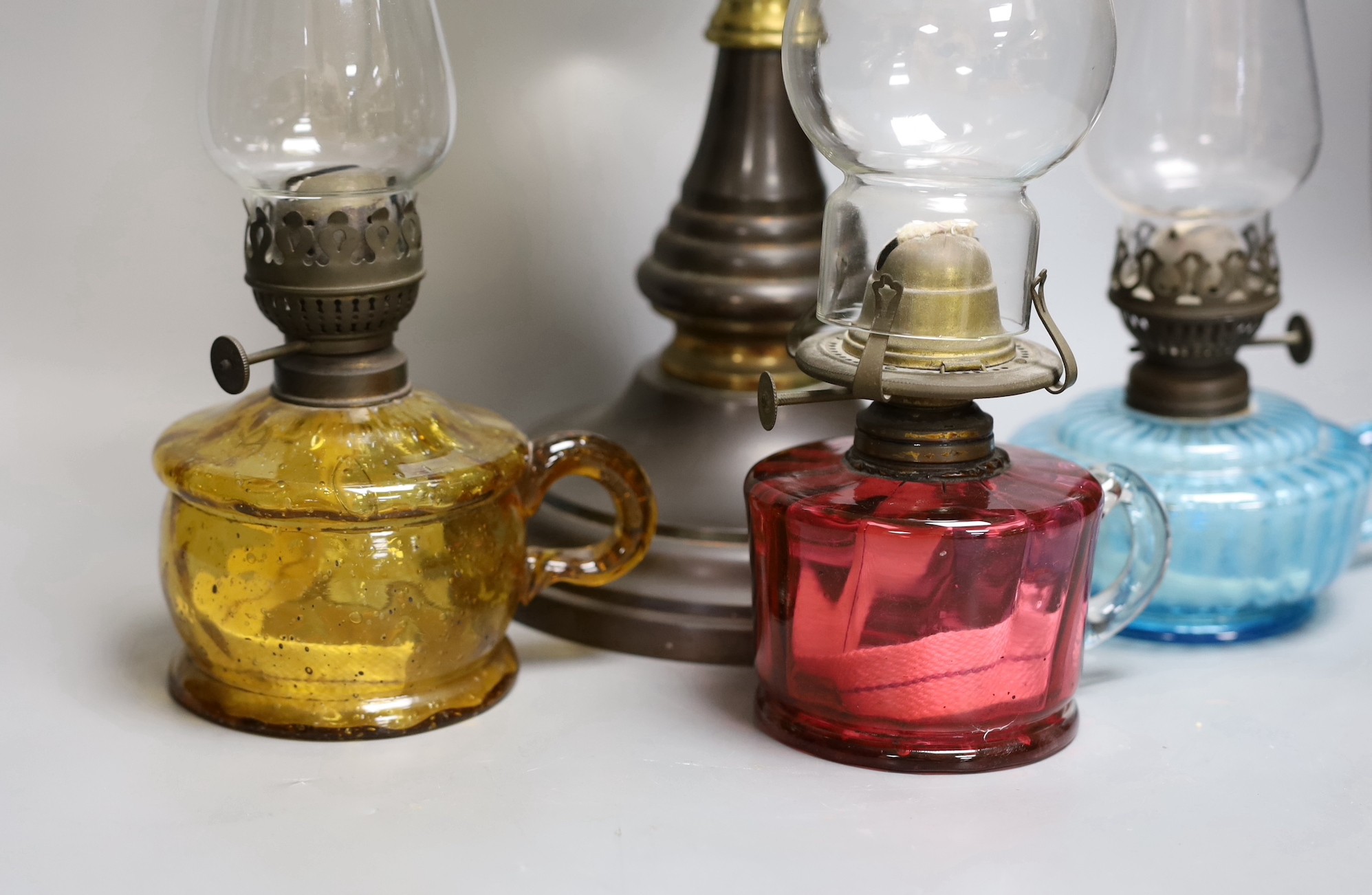 A Victorian oil lamp with vaseline glass shade and three small oil lamps, large oil lamp 49 cms high